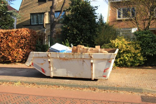 Workers loading office furniture into a van in Lewisham